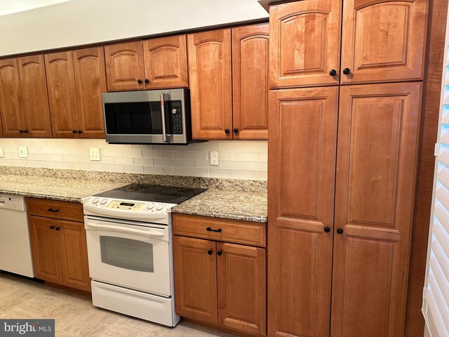 1341 Thornwood Dr, Mount Laurel, NJ 08054 - kitchen featuring white appliances, tasteful backsplash, light stone countertops, and brown cabinets