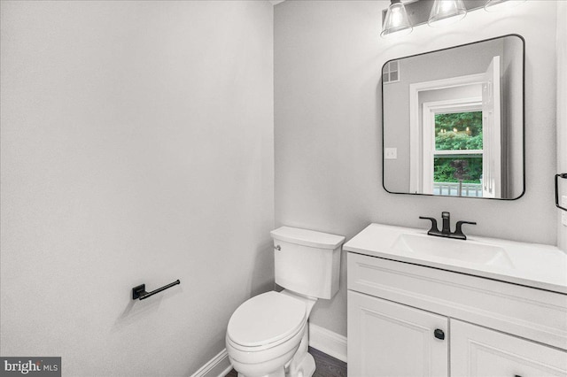 6121 Ducketts Ln, Elkridge, MD 21075 - bathroom featuring baseboards, toilet, and vanity
