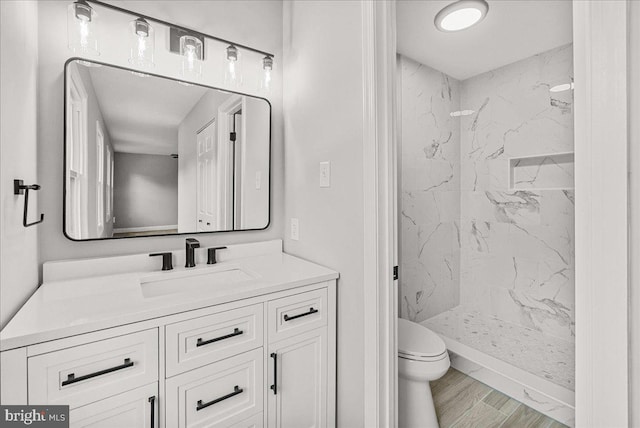 6121 Ducketts Ln, Elkridge, MD 21075 - bathroom featuring a marble finish shower, toilet, and vanity