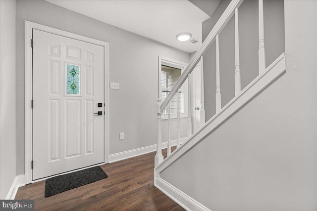6121 Ducketts Ln, Elkridge, MD 21075 - entrance foyer with dark wood-style floors, stairs, and baseboards