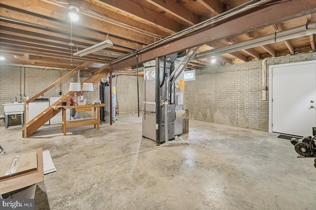 6121 Ducketts Ln, Elkridge, MD 21075 - below grade area featuring heating unit, brick wall, water heater, and a sink