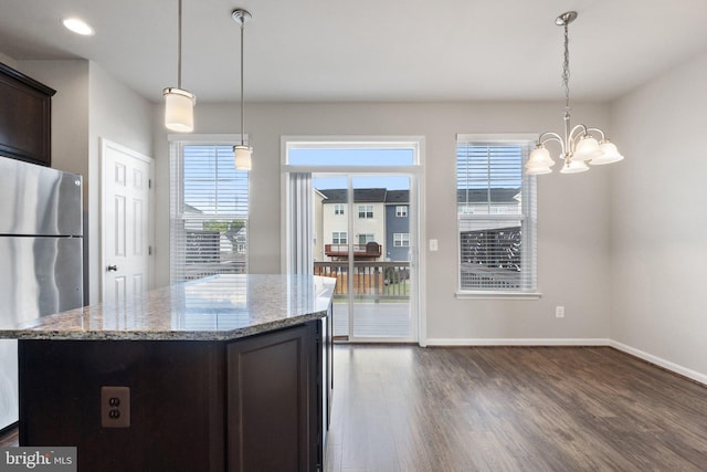 105 Poinsettia Way, Stephenson, VA 22656 - kitchen with freestanding refrigerator, dark wood-type flooring, a chandelier, dark brown cabinetry, and light stone countertops