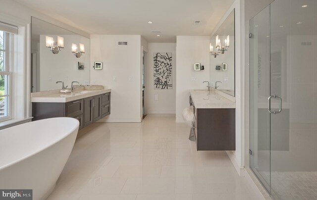 bathroom with a chandelier, a shower stall, and vanity