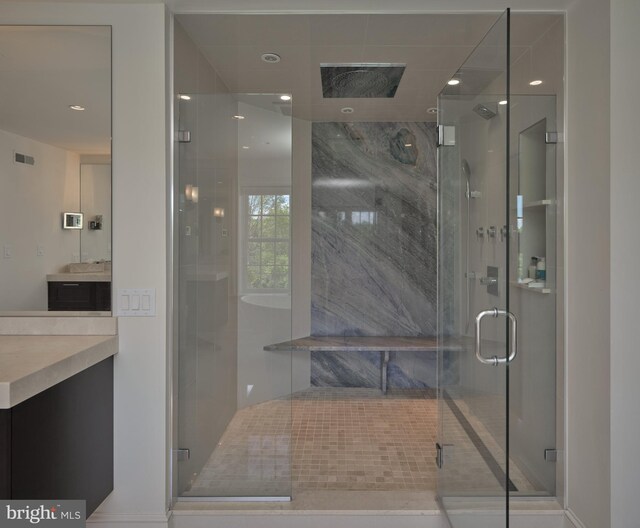 full bath featuring vanity, a shower stall, recessed lighting, and baseboards