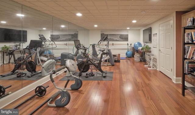 workout area with wood finished floors and baseboards