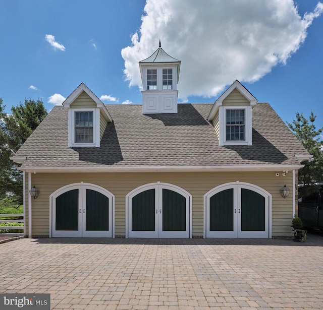 garage with french doors and driveway