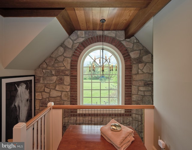 detailed view of a chandelier and beam ceiling