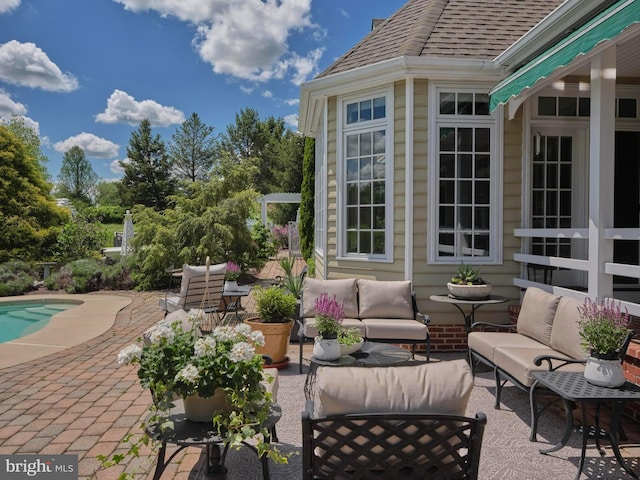 view of patio / terrace with outdoor lounge area and an outdoor pool