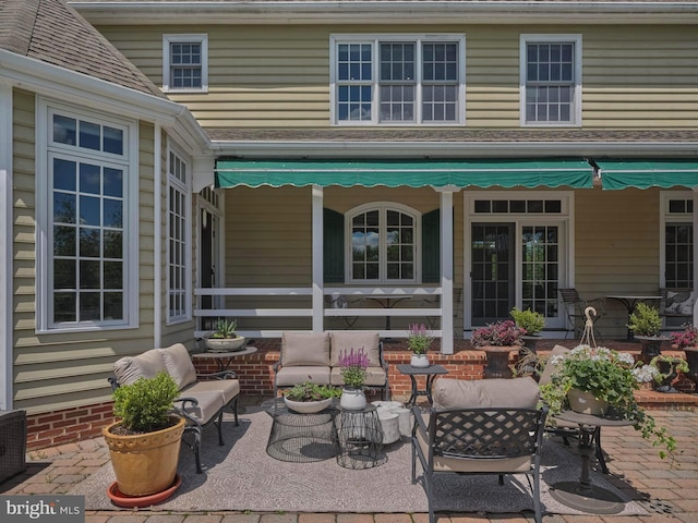 rear view of house featuring a patio and an outdoor hangout area