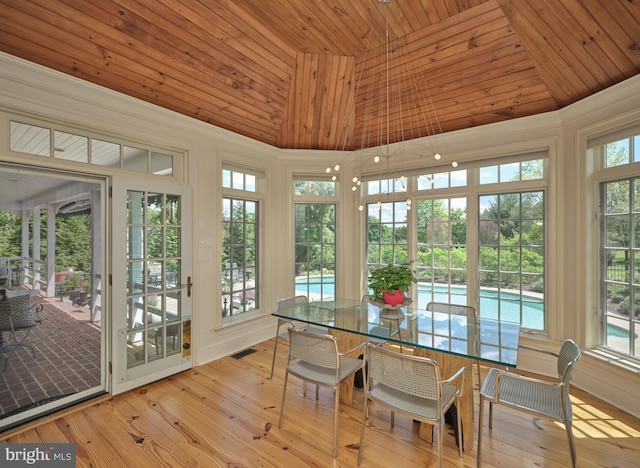 sunroom featuring wood ceiling, vaulted ceiling, and hardwood / wood-style floors
