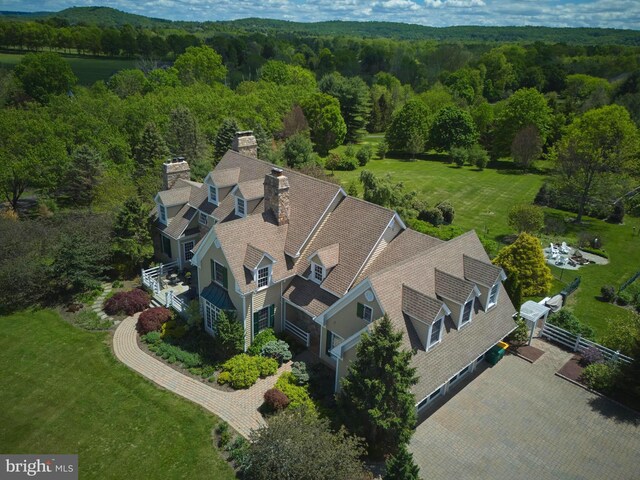 view of subject property featuring a heavily wooded area