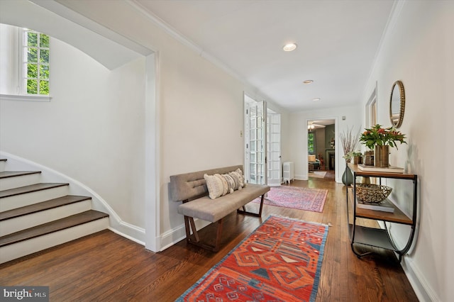 corridor with hardwood / wood-style flooring, stairs, crown molding, baseboards, and recessed lighting