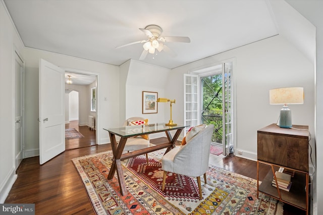 dining area featuring ceiling fan, wood finished floors, arched walkways, and baseboards