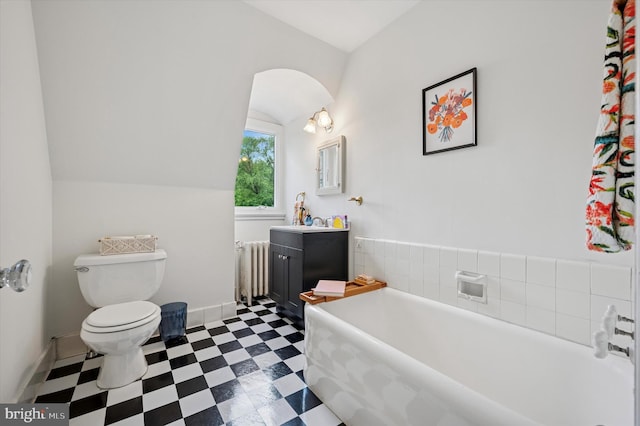full bathroom featuring radiator heating unit, vanity, toilet, tile patterned floors, and a bath