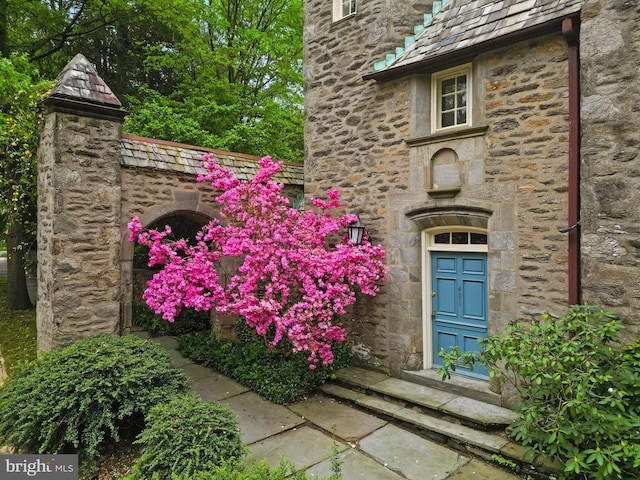 view of exterior entry featuring stone siding