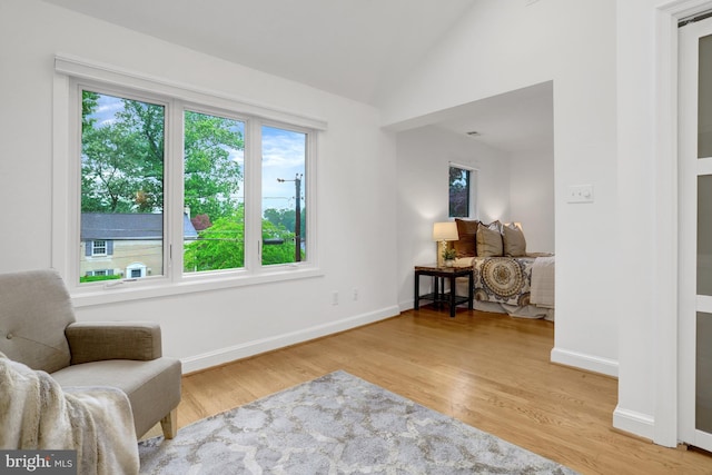 5018 36th St N, Arlington, VA 22207 - living area featuring vaulted ceiling, light wood finished floors, and baseboards