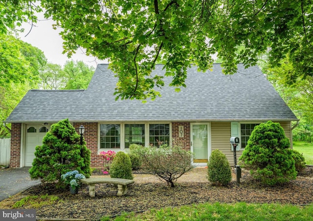 107 Juniper Dr, Levittown, PA 19056 - view of front of home featuring driveway, brick siding, roof with shingles, and an attached garage