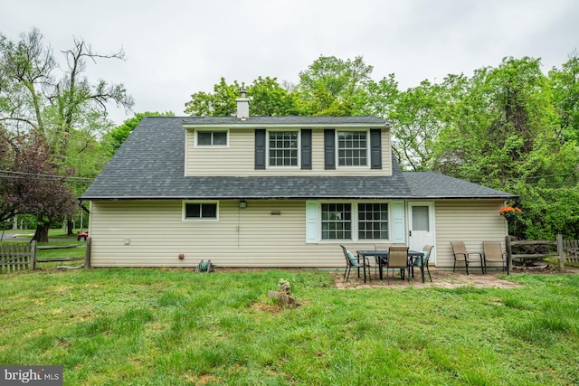 107 Juniper Dr, Levittown, PA 19056 - back of property featuring a yard, a chimney, fence, and roof with shingles