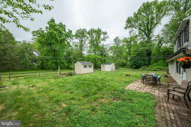 107 Juniper Dr, Levittown, PA 19056 - view of yard with an outdoor structure, a fenced backyard, a patio area, and a shed