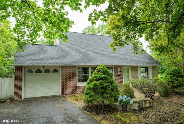 107 Juniper Dr, Levittown, PA 19056 - view of front of property with brick siding, aphalt driveway, a shingled roof, and a garage