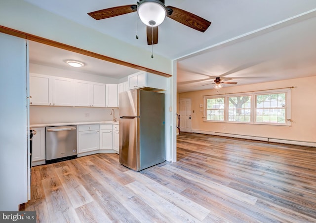 107 Juniper Dr, Levittown, PA 19056 - kitchen with a ceiling fan, a sink, light wood-style floors, stainless steel appliances, and white cabinets