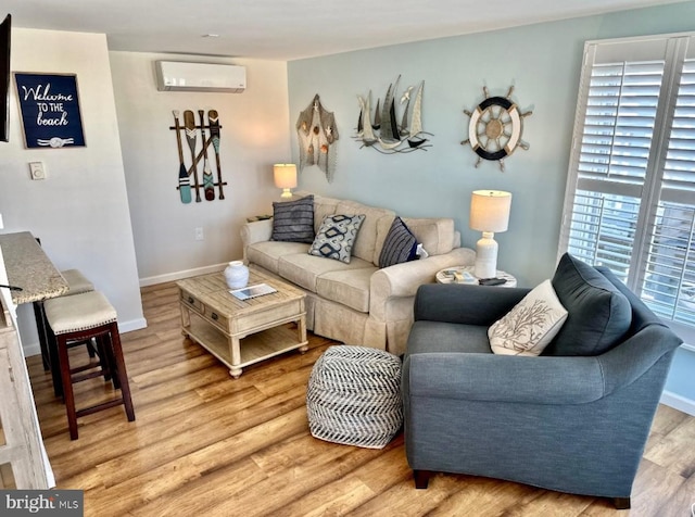 214 Leeward Ave, Beach Haven, NJ 08008 - living area with light wood-style flooring, baseboards, and an AC wall unit