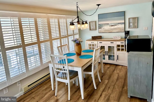 214 Leeward Ave, Beach Haven, NJ 08008 - dining room featuring a wealth of natural light, a notable chandelier, baseboard heating, and wood finished floors