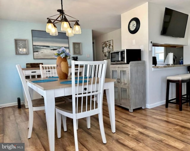 214 Leeward Ave, Beach Haven, NJ 08008 - dining space featuring an inviting chandelier, wood finished floors, and baseboards