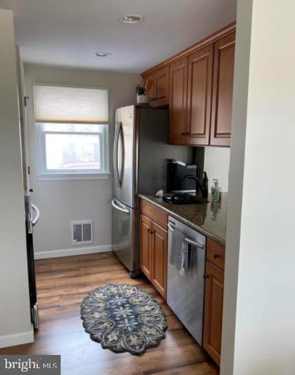 214 Leeward Ave, Beach Haven, NJ 08008 - kitchen featuring a sink, brown cabinets, visible vents, stainless steel dishwasher, and baseboards