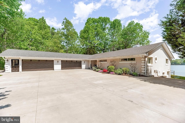 2031 Indian Cir, Saint Leonard, MD 20685 - ranch-style house featuring driveway, stucco siding, roof with shingles, and a garage