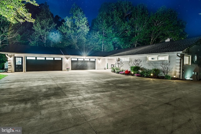 2031 Indian Cir, Saint Leonard, MD 20685 - view of front of home featuring an attached garage, stucco siding, driveway, and a chimney