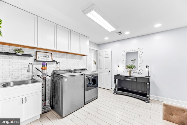2031 Indian Cir, Saint Leonard, MD 20685 - washroom featuring washer and dryer, a sink, cabinet space, visible vents, and recessed lighting