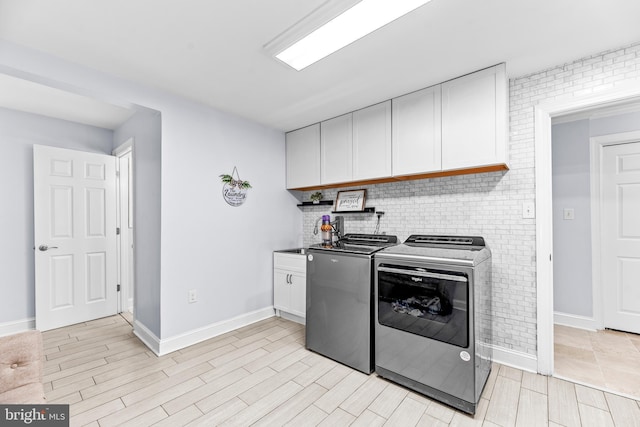 2031 Indian Cir, Saint Leonard, MD 20685 - kitchen with white cabinets, washing machine and clothes dryer, and baseboards