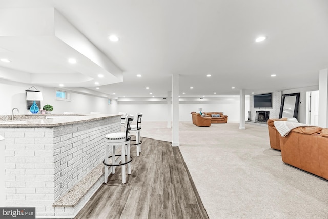 2031 Indian Cir, Saint Leonard, MD 20685 - bar with recessed lighting, a fireplace with raised hearth, light wood finished floors, a sink, and wet bar