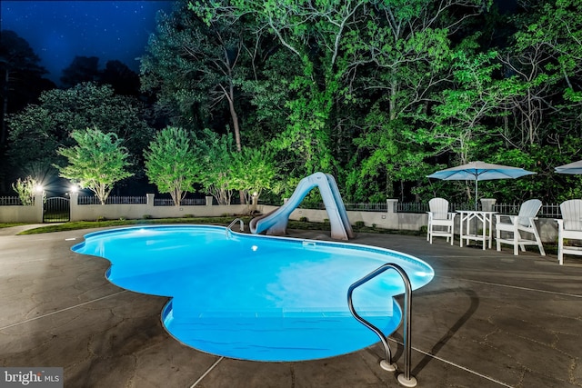 2031 Indian Cir, Saint Leonard, MD 20685 - view of swimming pool featuring a patio, a fenced in pool, a water slide, and a fenced backyard