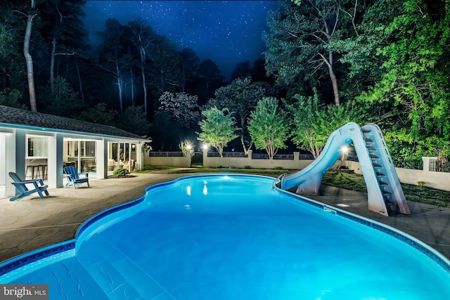 2031 Indian Cir, Saint Leonard, MD 20685 - view of swimming pool featuring a patio area, a water slide, an outbuilding, a fenced backyard, and a fenced in pool