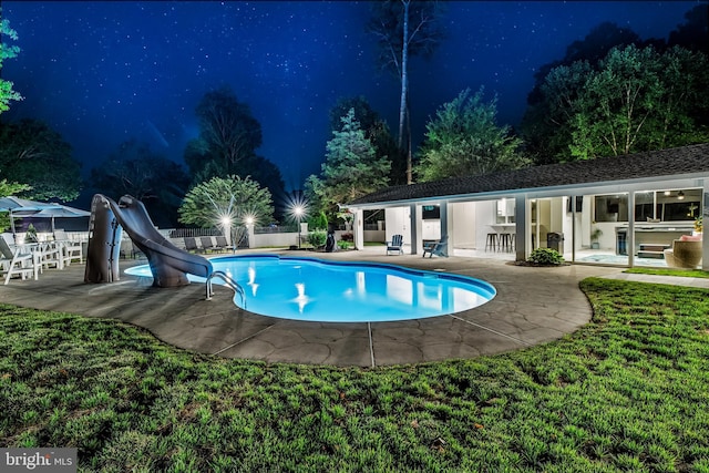 2031 Indian Cir, Saint Leonard, MD 20685 - pool at night featuring an outbuilding, a fenced in pool, fence, a patio area, and a water slide