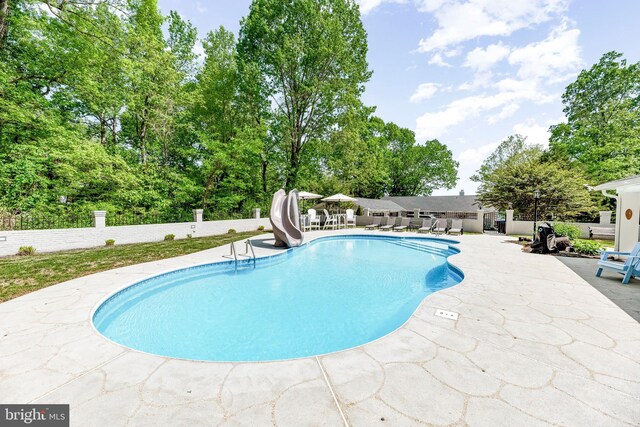 2031 Indian Cir, Saint Leonard, MD 20685 - view of swimming pool featuring a patio, a fenced in pool, a water slide, and fence