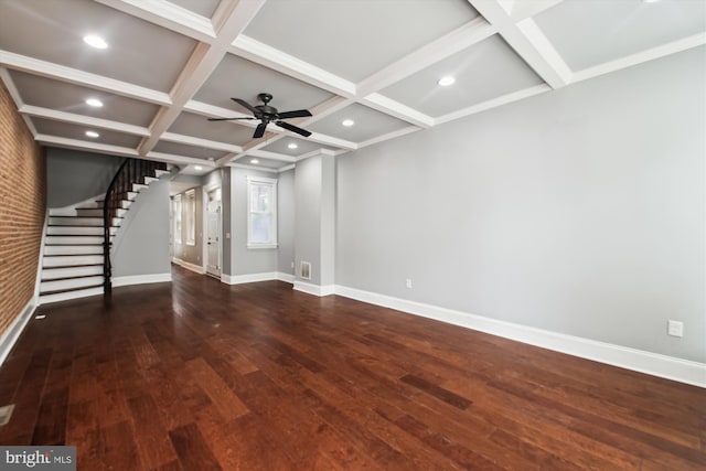 unfurnished living room featuring coffered ceiling, baseboards, wood finished floors, stairway, and beam ceiling