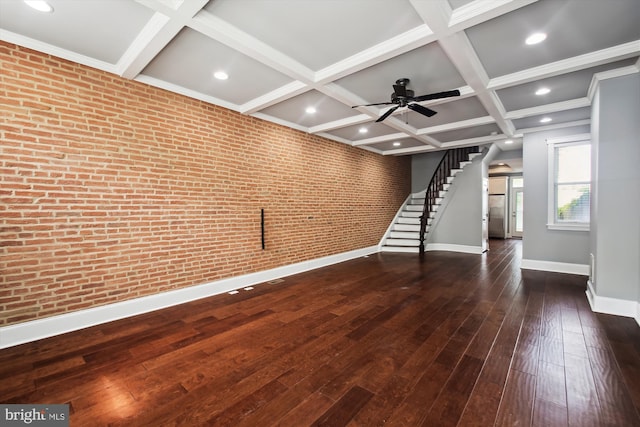 unfurnished living room featuring baseboards, coffered ceiling, hardwood / wood-style flooring, ceiling fan, and stairs