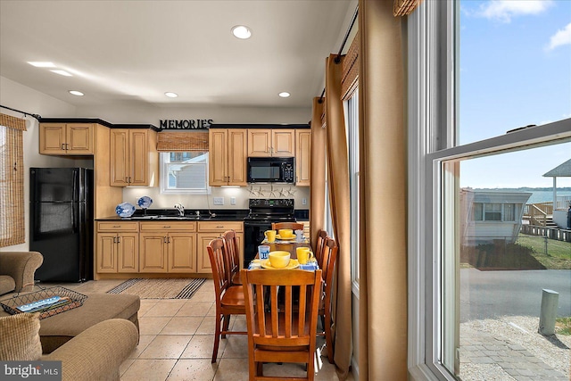 22 Flounder Ln, Ocean City, MD 21842 - kitchen featuring a sink, black appliances, recessed lighting, light tile patterned floors, and dark countertops