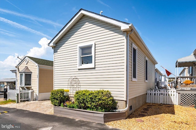 22 Flounder Ln, Ocean City, MD 21842 - view of home's exterior with a deck and fence