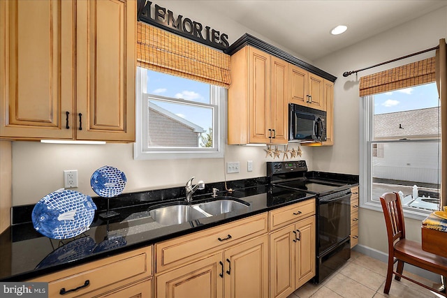 22 Flounder Ln, Ocean City, MD 21842 - kitchen with light tile patterned floors, dark stone countertops, a sink, black appliances, and recessed lighting