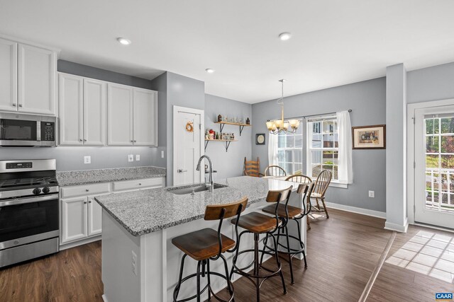 4286 Sunset Dr, Charlottesville, VA 22911 - kitchen with stainless steel appliances, a sink, dark wood-style floors, white cabinetry, and a breakfast bar