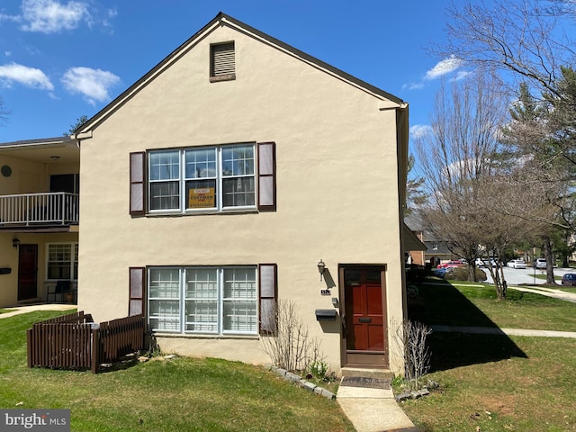 371 Old Forge Xing Unit 371, Devon, PA 19333 - rear view of house with stucco siding and a yard