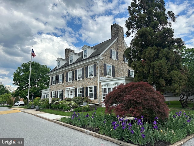 371 Old Forge Xing Unit 371, Devon, PA 19333 - view of home's exterior featuring a chimney and stone siding