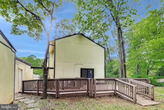 back of property featuring a deck