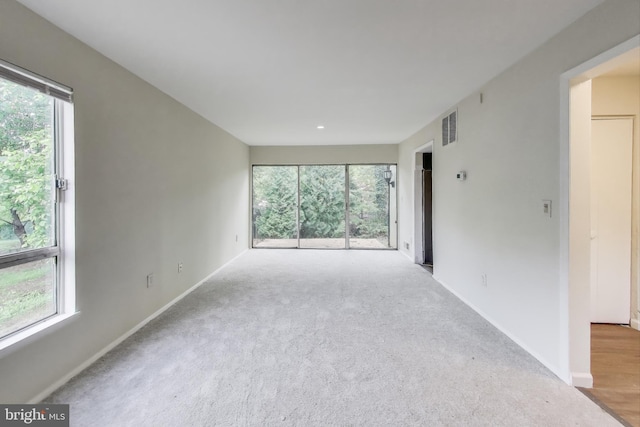 spare room with baseboards and carpet flooring