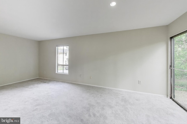 empty room featuring carpet and baseboards
