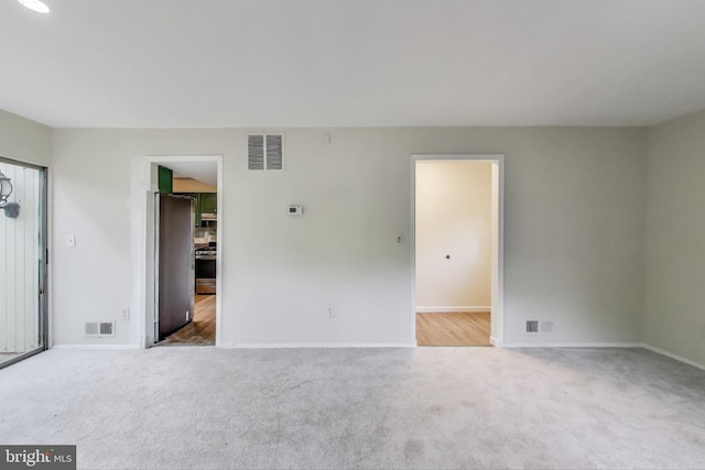 carpeted spare room with baseboards
